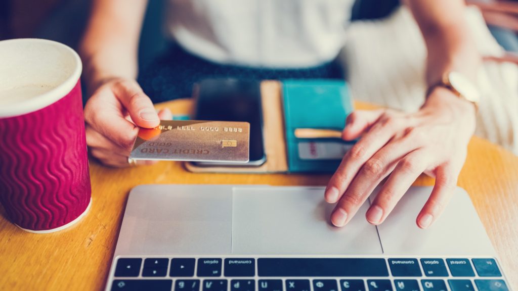 A woman shopping online with a credit card